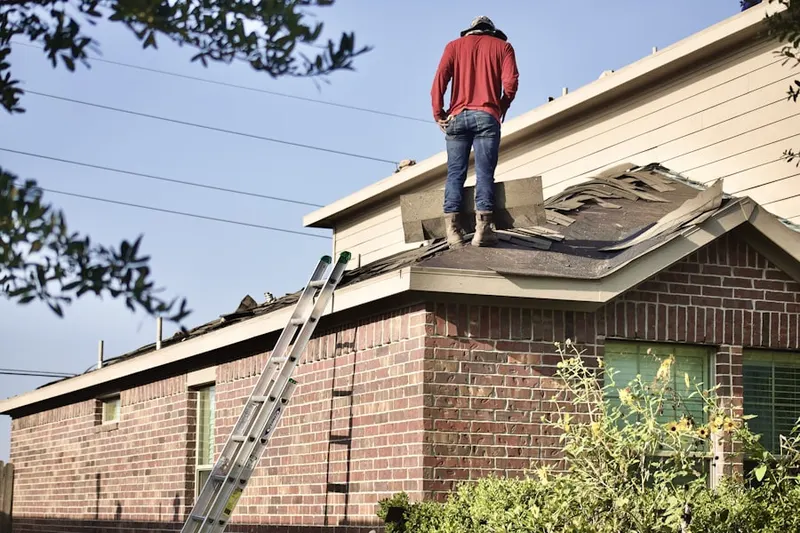 Professional roofer working on a residential roof in Moline